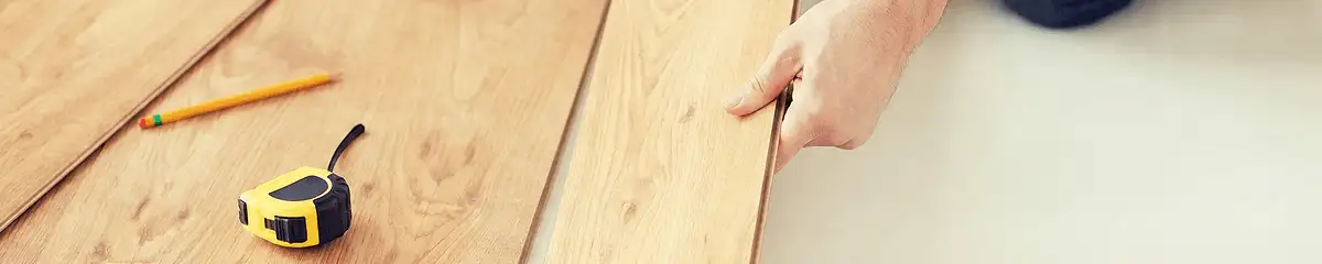 A professional installing wood flooring in Syracuse, NY