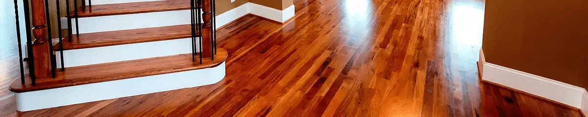 Base floor of a staircase with professionally restored wood flooring in Syracuse NY