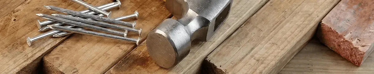 Hammer and nails on hardwood flooring boards in Syracuse, NY