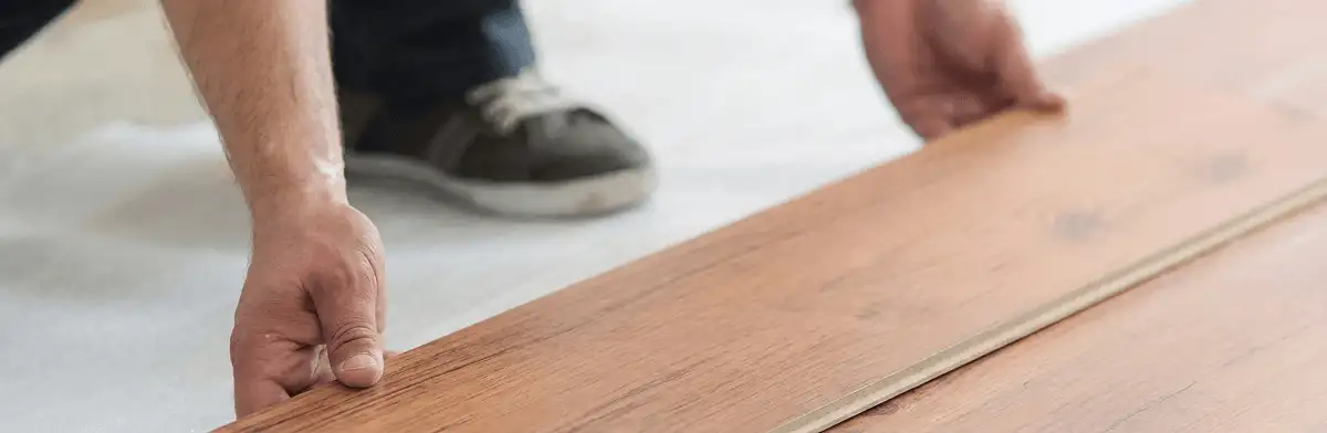 A professional installing laminate flooring in Syracuse, NY