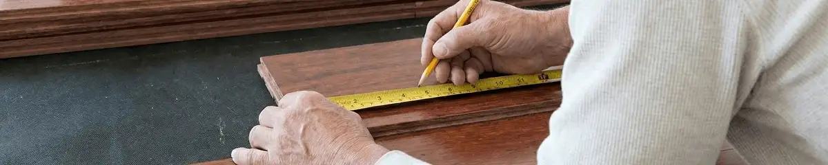 A professional installing wood flooring in Syracuse, NY